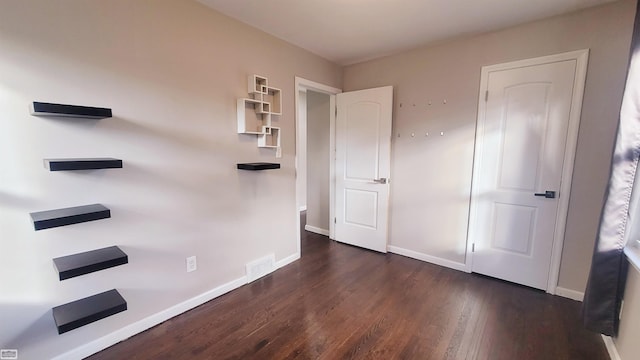 unfurnished bedroom featuring dark hardwood / wood-style floors