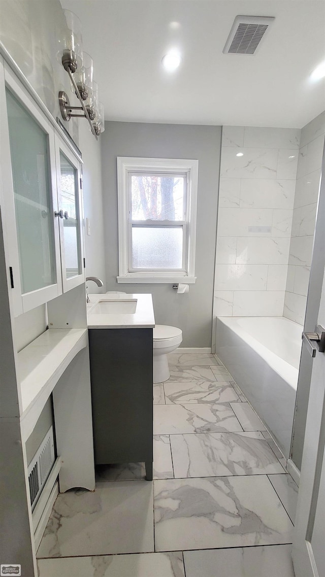 full bathroom featuring washtub / shower combination, vanity, a chandelier, and toilet