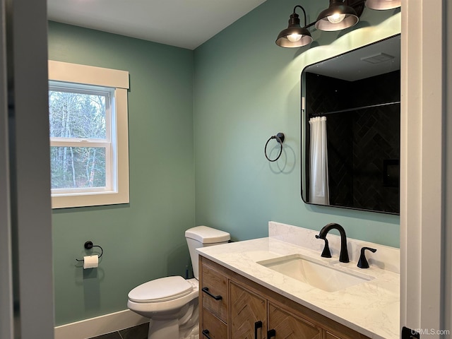 bathroom featuring curtained shower, vanity, tile patterned floors, and toilet