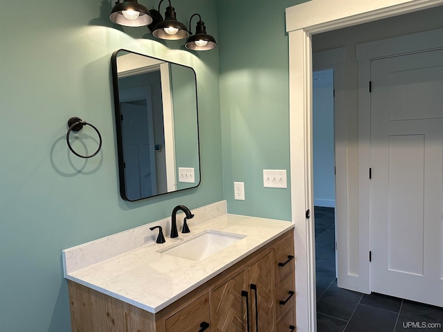 bathroom with a chandelier, vanity, and tile patterned flooring