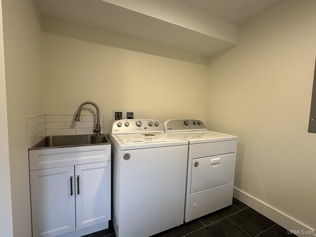 11881 N Junet Rd, Ironwood, MI 49938 - clothes washing area featuring washer and dryer, dark tile patterned flooring, baseboards, and cabinet space
