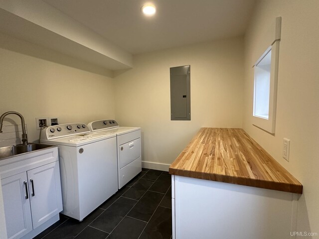 11881 N Junet Rd, Ironwood, MI 49938 - washroom featuring electric panel, washer and dryer, cabinet space, and dark tile patterned flooring
