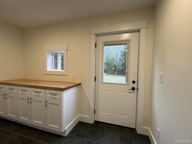 11881 N Junet Rd, Ironwood, MI 49938 - entryway with dark tile patterned floors and baseboards