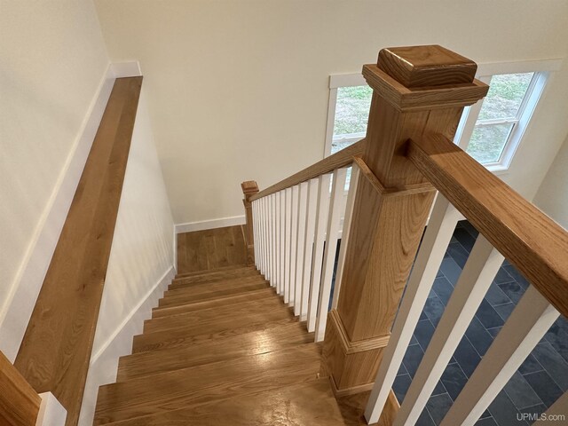 11881 N Junet Rd, Ironwood, MI 49938 - staircase with baseboards and wood finished floors