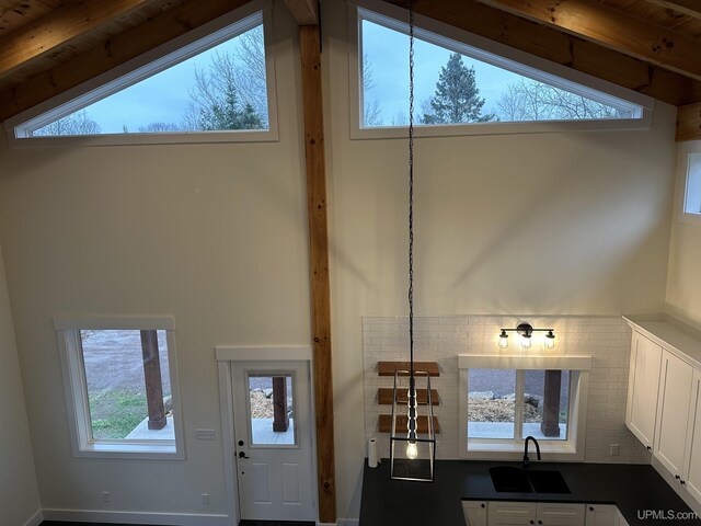 11881 N Junet Rd, Ironwood, MI 49938 - kitchen view of a sink, dark countertops, and white cabinets
