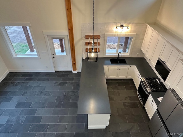 kitchen featuring white cabinets, hanging light fixtures, and sink