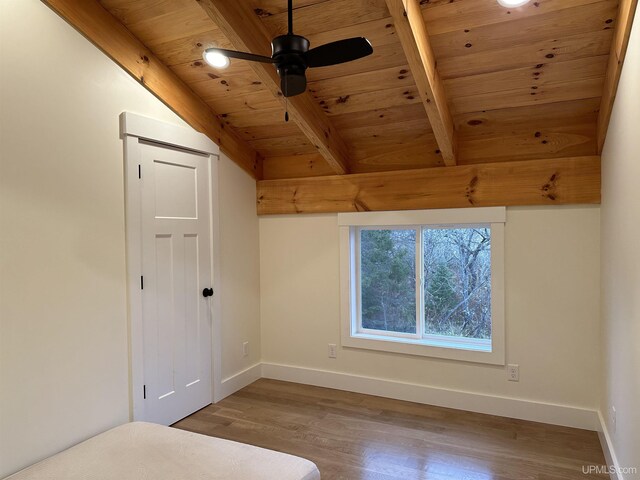 11881 N Junet Rd, Ironwood, MI 49938 - unfurnished bedroom with wood ceiling, baseboards, wood finished floors, beamed ceiling, and a closet