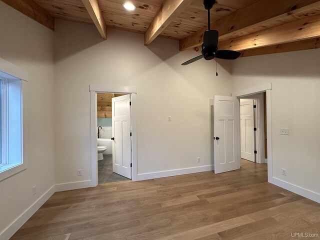 11881 N Junet Rd, Ironwood, MI 49938 - unfurnished bedroom with wooden ceiling, beamed ceiling, baseboards, high vaulted ceiling, and connected bathroom