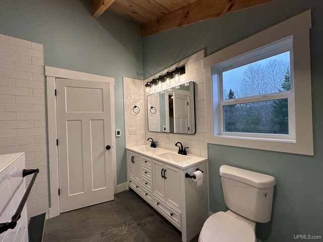 11881 N Junet Rd, Ironwood, MI 49938 - full bathroom featuring wood ceiling, toilet, beam ceiling, double vanity, and tasteful backsplash