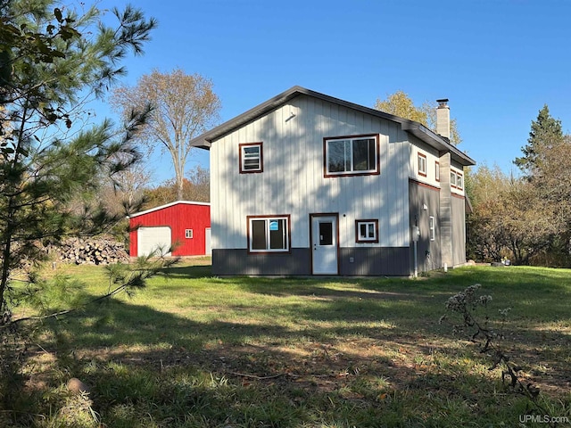 back of house with a lawn