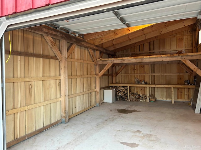 garage featuring wood walls