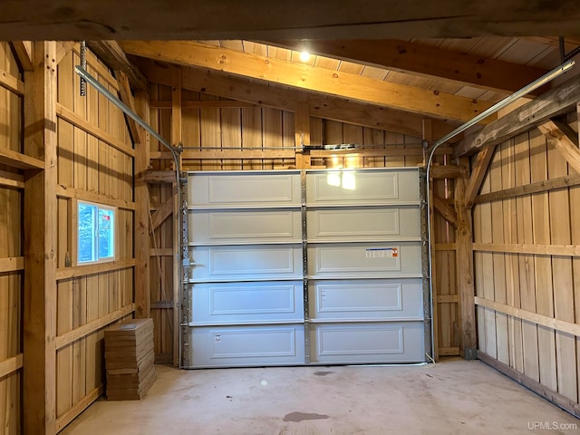 garage with wood ceiling and wooden walls