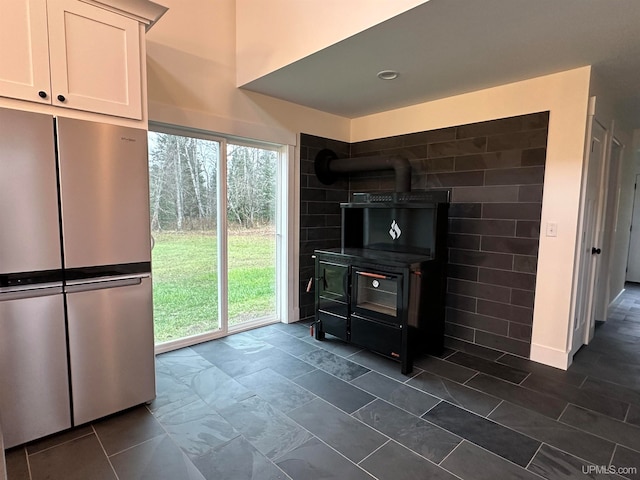 kitchen featuring stainless steel fridge and white cabinets