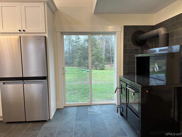 11881 N Junet Rd, Ironwood, MI 49938 - kitchen with freestanding refrigerator and white cabinets