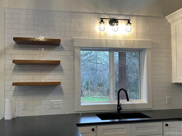 11881 N Junet Rd, Ironwood, MI 49938 - kitchen featuring a sink, dark countertops, white cabinetry, and open shelves
