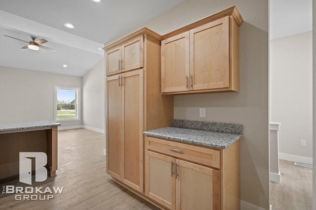 kitchen with baseboards, light brown cabinets, and light wood-type flooring
