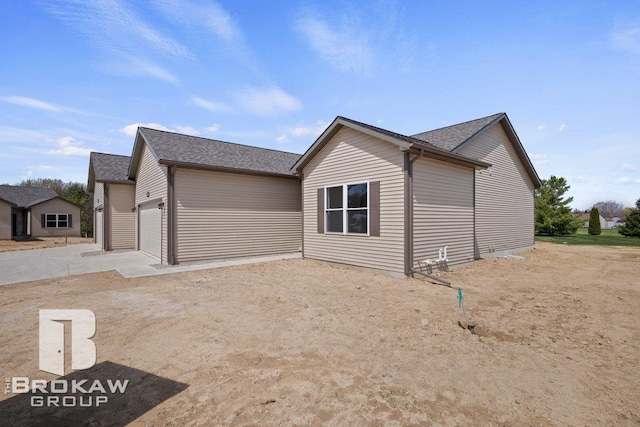 3371 Meadowridge Ct Unit 107, Davison, MI 48423 - view of home's exterior featuring a garage, driveway, and a shingled roof