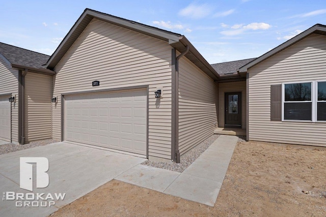 ranch-style home with driveway and a garage