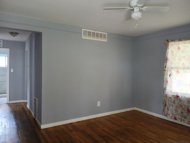 empty room with dark hardwood / wood-style floors and ceiling fan