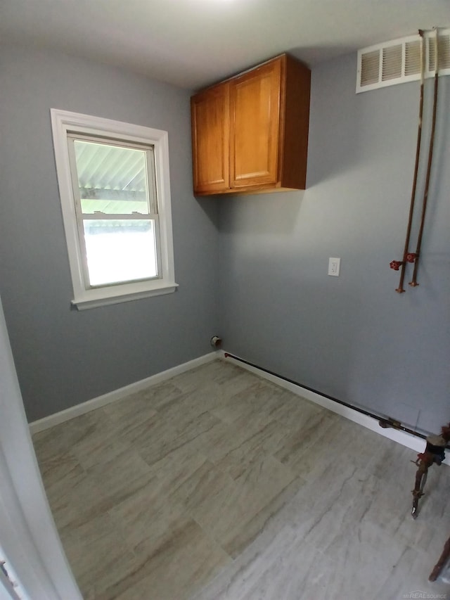 laundry area with cabinets