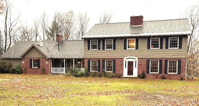 colonial-style house with a front yard