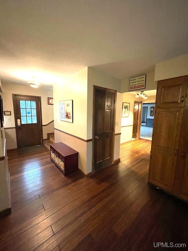 hallway with dark hardwood / wood-style floors