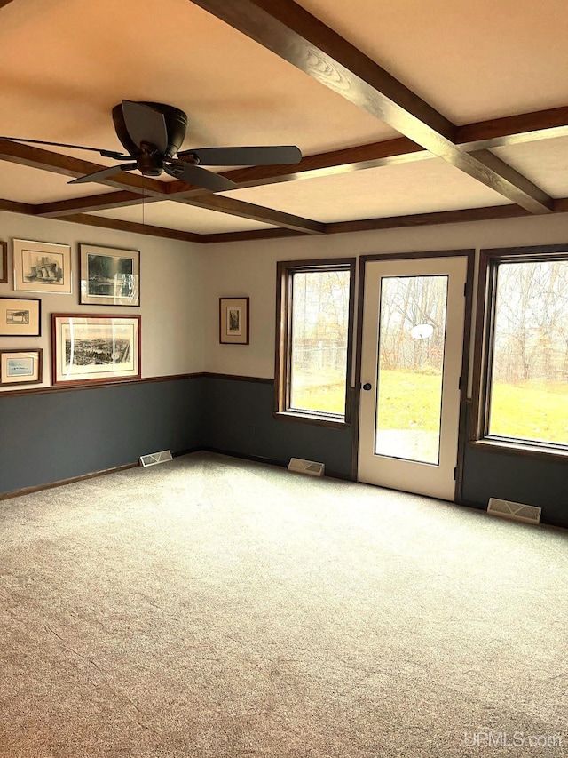 carpeted spare room with beam ceiling and ceiling fan