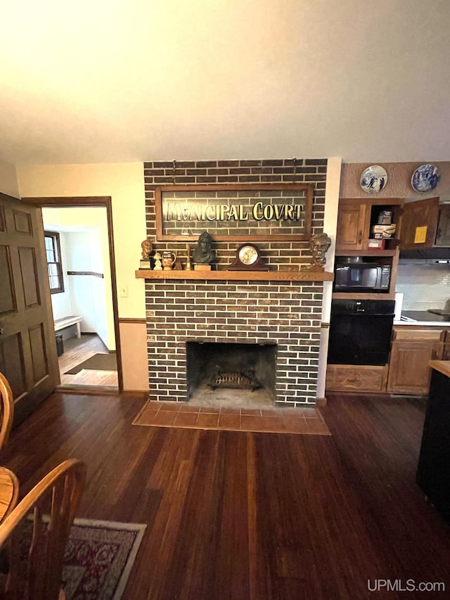 living room featuring a fireplace and dark hardwood / wood-style floors