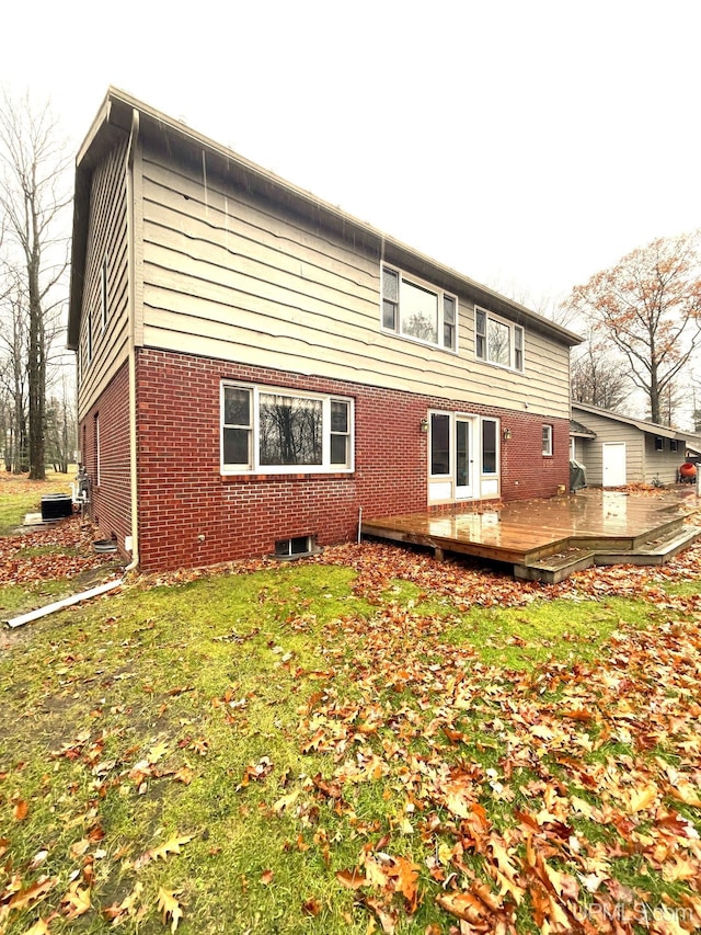 back of property with a wooden deck