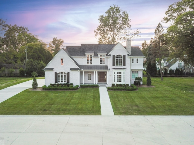 view of front facade with a front lawn and a chimney