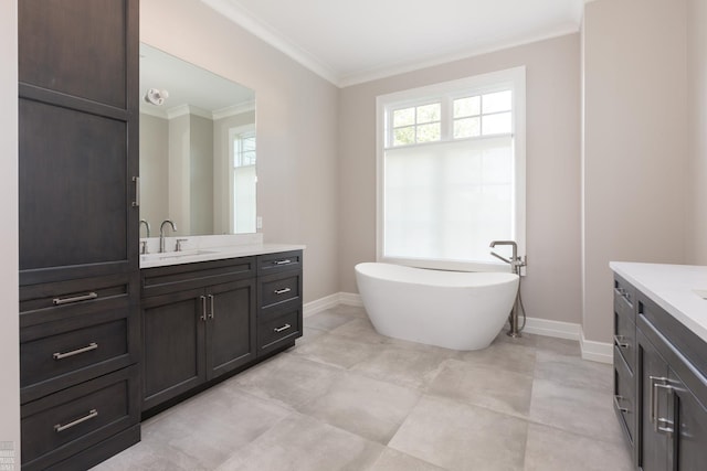 bathroom with ornamental molding, vanity, and a tub