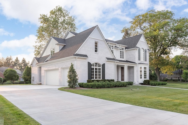 view of front of property featuring a garage and a front lawn