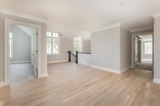 spare room with light wood-type flooring and ornamental molding