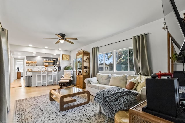 living room with hardwood / wood-style flooring and ceiling fan