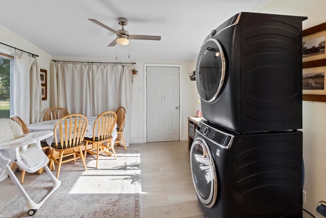 washroom with ceiling fan, stacked washer and clothes dryer, and light hardwood / wood-style flooring