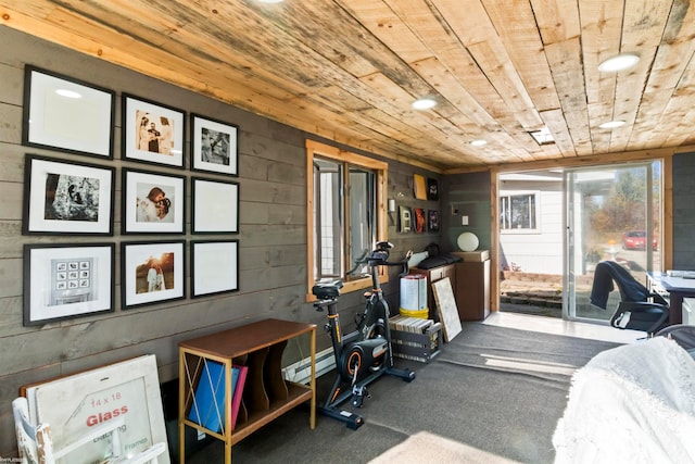 exercise room featuring wooden ceiling, wooden walls, and carpet flooring