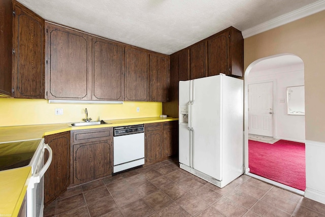 kitchen with white appliances, sink, dark brown cabinetry, and a textured ceiling