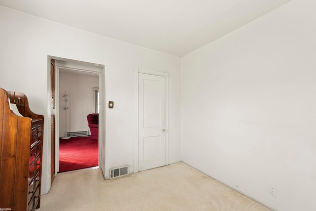 unfurnished room with light colored carpet