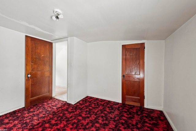 interior space featuring carpet flooring and lofted ceiling