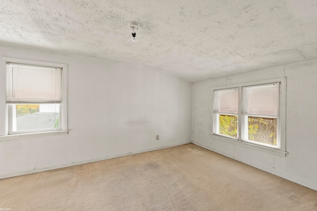 carpeted spare room featuring a textured ceiling