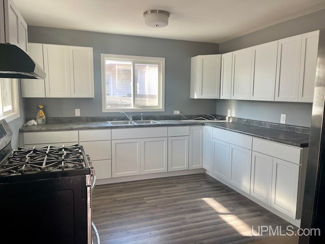 kitchen with white cabinets, dark wood-type flooring, sink, and gas stove