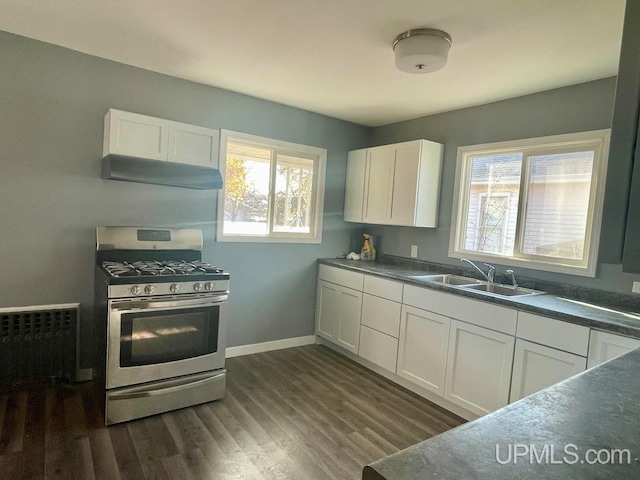 kitchen with white cabinetry, plenty of natural light, dark hardwood / wood-style floors, and stainless steel gas range oven