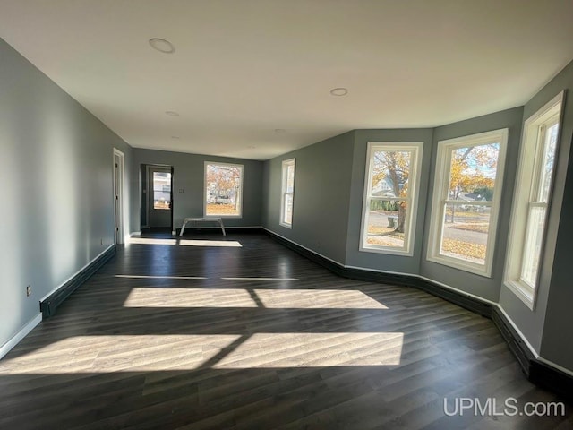 unfurnished room featuring dark hardwood / wood-style floors