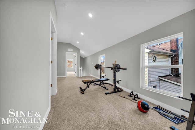 exercise room with carpet and vaulted ceiling