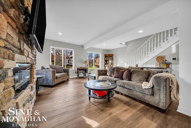 living room with hardwood / wood-style floors and a fireplace