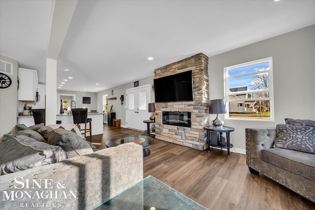 living room featuring hardwood / wood-style floors and a fireplace