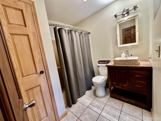 bathroom featuring tile patterned flooring, a shower with curtain, vanity, and toilet