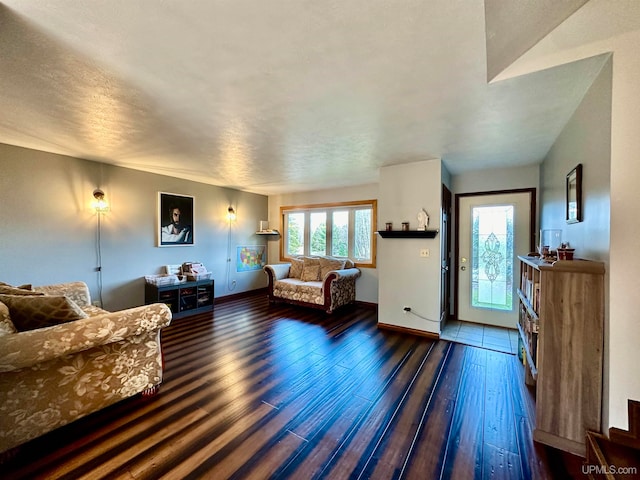 living room featuring a textured ceiling, dark hardwood / wood-style floors, and plenty of natural light