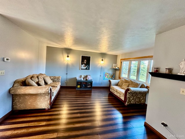 living room with dark hardwood / wood-style flooring and a textured ceiling