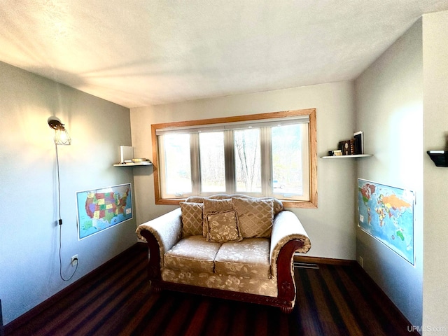 sitting room with a textured ceiling and dark hardwood / wood-style floors